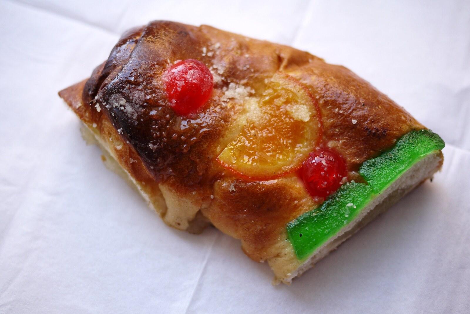 Slice of Catalan tortell de Reis decorated with glazed fruit